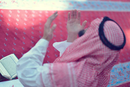 Handsome Younger Muslim Arabic man praying in mosque