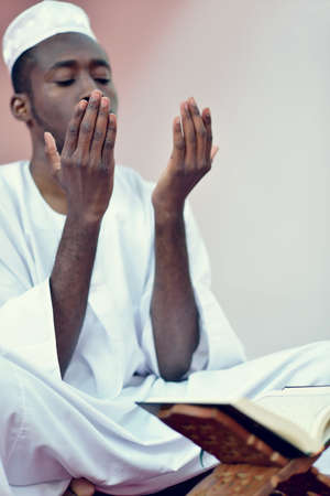 African Muslim Man Making Traditional Praying To God While Wearing A Traditional Cap Dishdashaの写真素材
