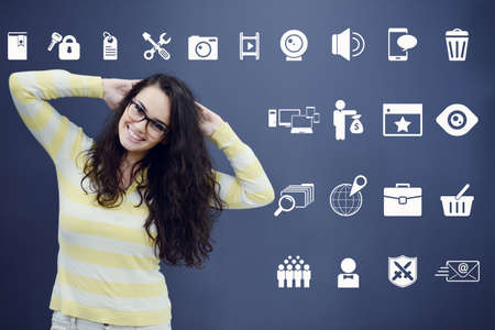 Cheerful young woman with background with drawn business chart, arrow and icons. Successful business conceptの写真素材