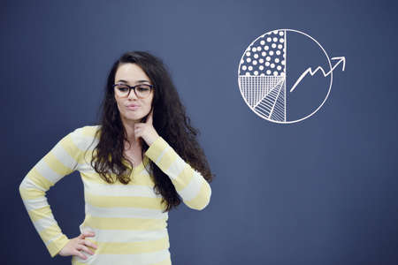 Young woman with background with drawn business chart, arrow and icons. Successful business concept