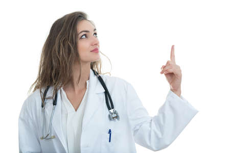 medical doctor woman smile with stethoscope and hand showing something, concept of advertisement product, empty copy space. Isolated over white backgroundの写真素材