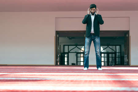 Young beautiful Muslim Man Praying In Mosque.