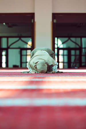 Young beautiful Muslim Woman Praying In Mosque.の写真素材