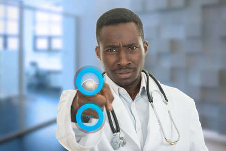 Closeup portrait of friendly, smiling confident Muslim female doctor holding medical symbols in modern hospitalの写真素材