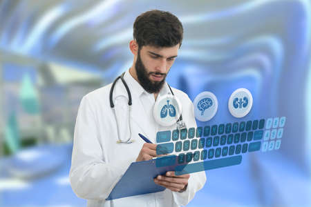 Worried young doctor with beard holding paperclip with medical symbols in background.の写真素材