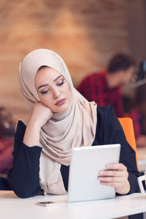 Arabic business woman wearing hijab,working in startup office.の写真素材