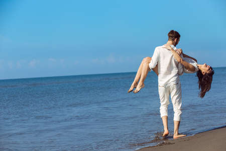 romance on vacation: couple in love on the beach flirtingの写真素材