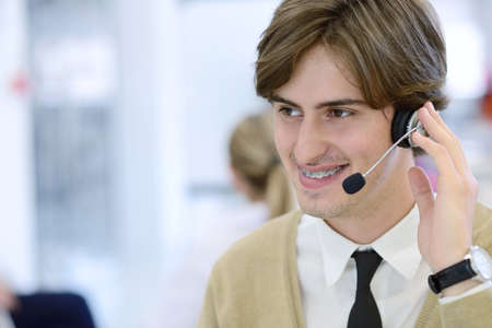 Smiling young call center executive at startup office