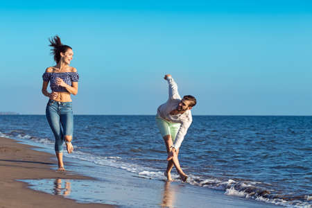 happy couple running on the beachの写真素材