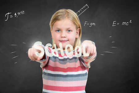 Little girl pointing on school sign with handの写真素材