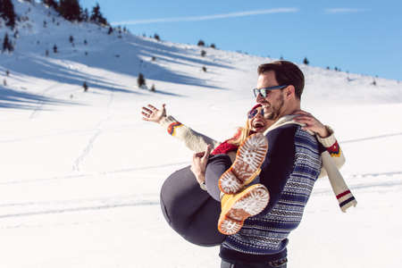 Happy Couple Having Fun on snow mountain.の写真素材