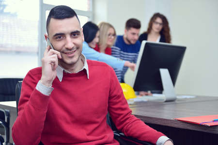 business concept - businessman talking on the phone in office
