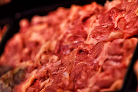 Heap of fresh raw meat food flesh background at shop supermarketの写真素材