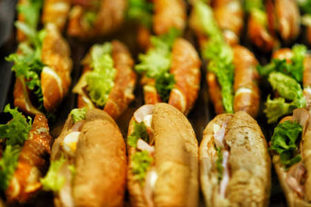 Beautifully decorated catering banquet table with different food snacks and appetizers with sandwich.の写真素材
