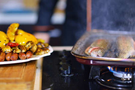 Grilled sausage with grilled vegetables on kitchen tableの写真素材