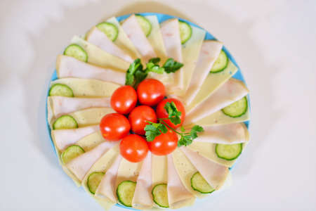 Food tray with delicious salami tomatoes, salad and vegetableの写真素材