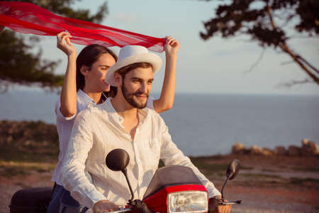 Couple in love riding a motorbike , Handsome guy and young sexy woman travel .の写真素材