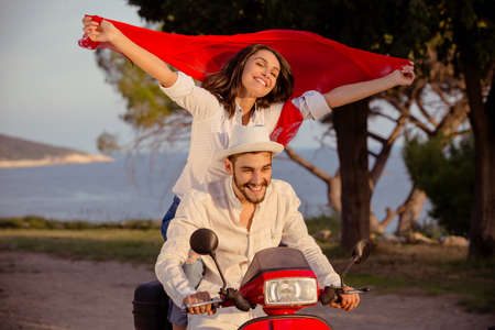 Couple in love riding a motorbike , Handsome guy and young sexy woman travel .