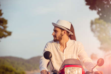 Couple in love riding a motorbike , Handsome guy and young sexy woman travel .の写真素材