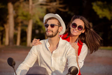 Couple in love riding a motorbike , Handsome guy and young sexy woman travel .
