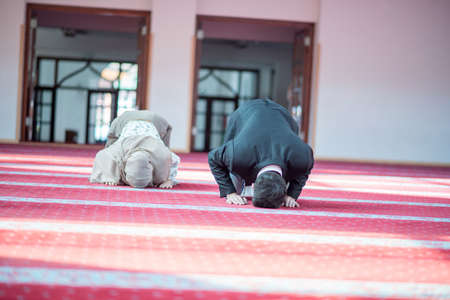 Muslim man and woman prayingの写真素材