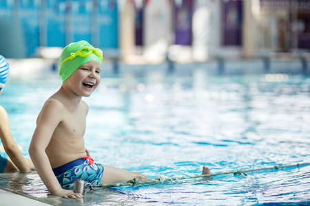 happy children kids group at swimming pool class learning to swimの写真素材