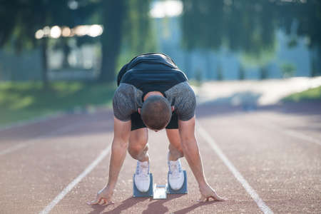 Sprinter leaving starting blocks on the running track. Explosive startの写真素材