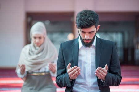 Muslim man and woman prayingの写真素材