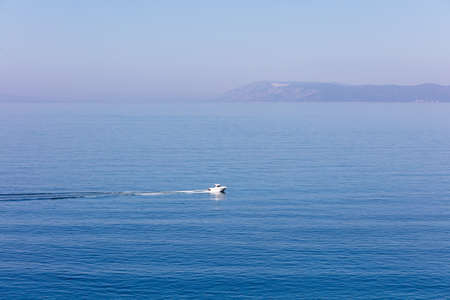 Aerial view of small boat flowing in sea, travel and vacation conceptの写真素材