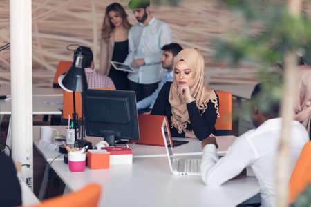 Arabic business woman wearing hijab,working in startup office.