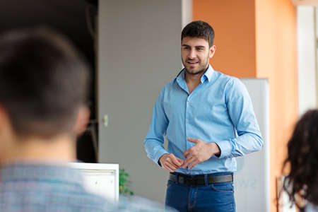 business, startup, presentation, strategy and people concept - man making presentation to creative...
