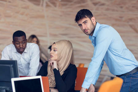 Multiracial contemporary business people working connected with technological devices like tablet and laptop, talking together - finance, business, technology conceptの写真素材