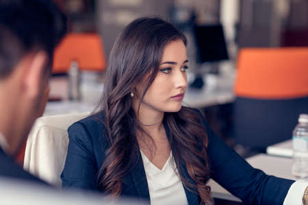Young pretty business woman with notebook in the officeの写真素材