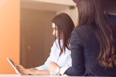 startup business young creative people group brainstorming on meeting at office using laptop and tablet computerの写真素材