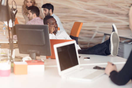 African American businessman sitting at the computer in startup office