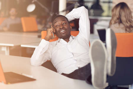 African American businessman sitting at the computer in startup officeの写真素材