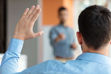 Business people Raising there Hand Up at a Conference to answer a questionの写真素材