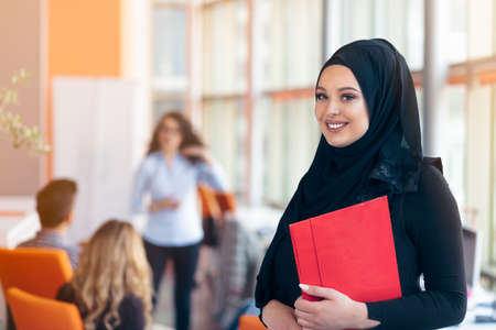 Arabian business woman with hijab holding a folderの写真素材