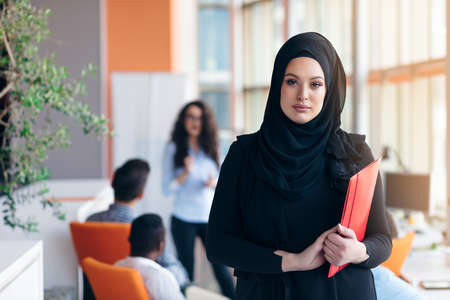 Arabian business woman with hijab holding a folderの写真素材