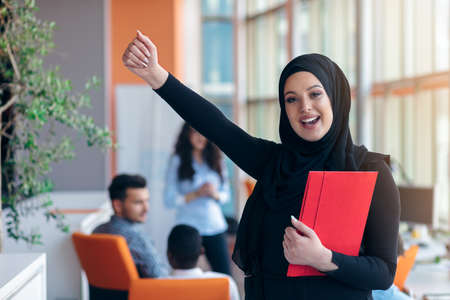 Arabian business woman with hijab holding a folderの写真素材