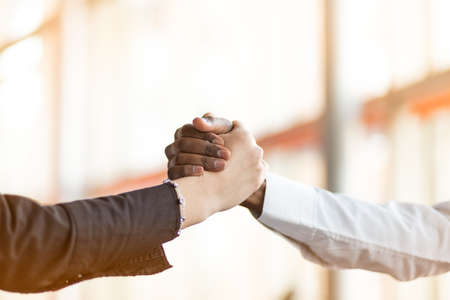 People at work: man and woman hand shaking at a meetingの写真素材