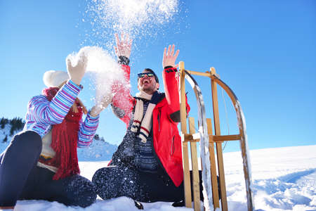 Carefree happy young couple having fun together in snow.の写真素材