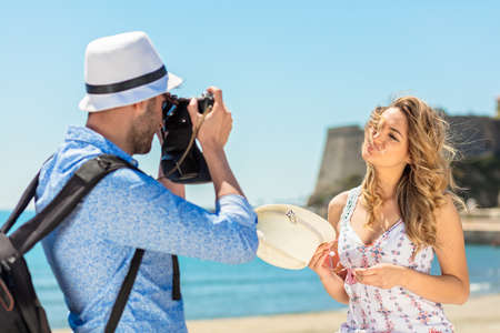 Happy Tourist Couple Enjoying City And Taking Photo