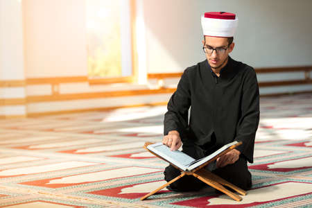 Religious muslim man praying inside the mosque