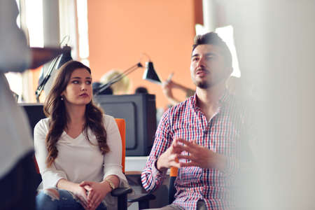 business, startup, presentation, strategy and people concept - man on presentation with group of people at officeの写真素材