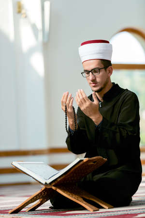 Religious muslim man praying inside the mosque
