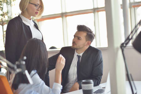 Team job. Photo young businessmans crew working with new startup project in modern loft.の写真素材