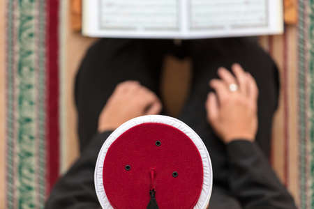 Top view of a religious muslim man praying inside the mosque