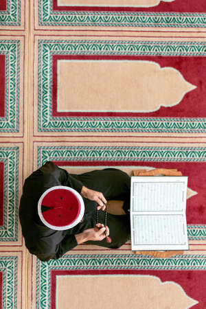 Top view of a religious muslim man praying inside the mosqueの写真素材