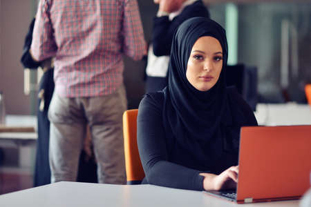 Multiracial contemporary business people working connected with technological devices like tablet and laptopの写真素材